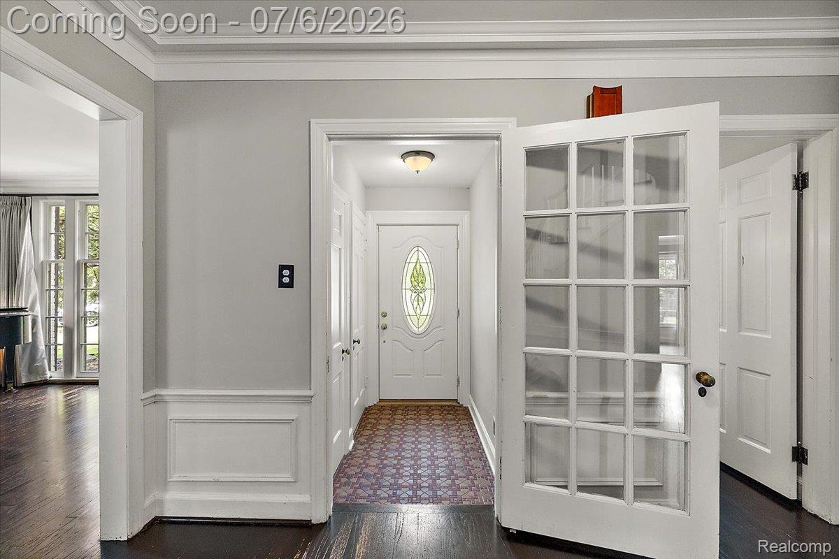 1051 Devonshire Road Grosse Pointe, MI 48230 - Photo 12 of 98 Entryway featuring a white paneled door with glass inserts, dark wood-finish flooring, and crown molding
