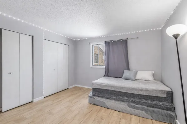 a bedroom with a bed and a window