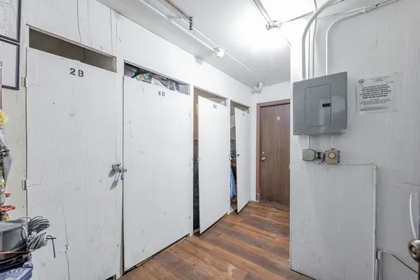 a view of a hallway with closet and wooden floor