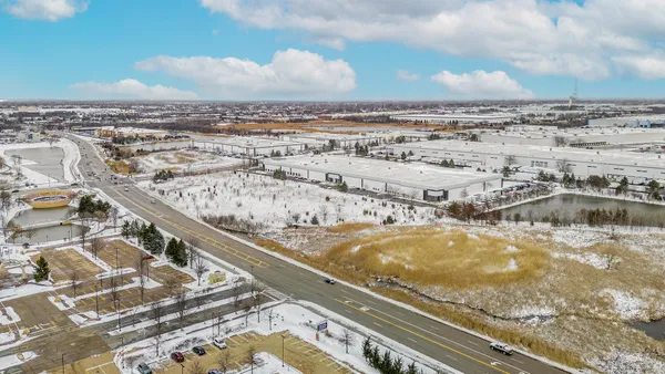 an aerial view of a residential building and parking space