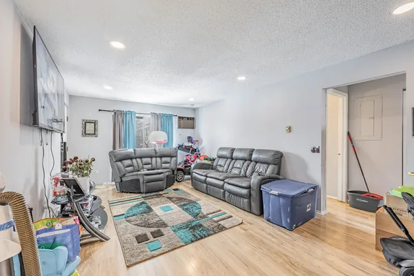 a living room with furniture and a wooden floor
