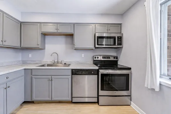 a kitchen with stainless steel appliances granite countertop a stove and a microwave