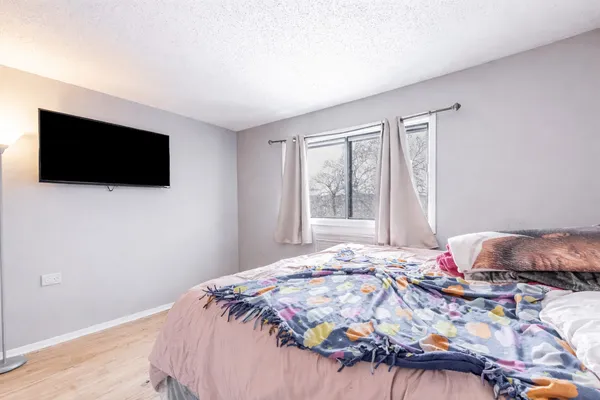 a bedroom with a bed and a flat screen tv