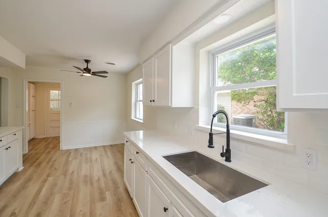 a kitchen with a sink stove and cabinets