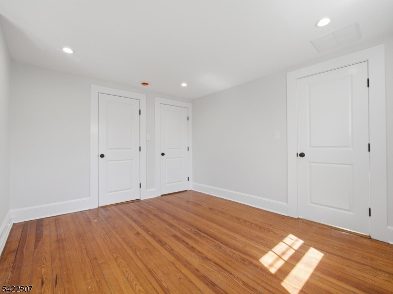 46 West End Avenue, Unit LEFT Summit, NJ 07901 - Photo 12 of 19 a view of empty room with wooden floor and fan