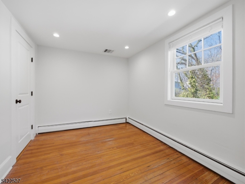 46 West End Avenue, Unit LEFT Summit, NJ 07901 - Photo 13 of 19 a view of a room with wooden floor and window
