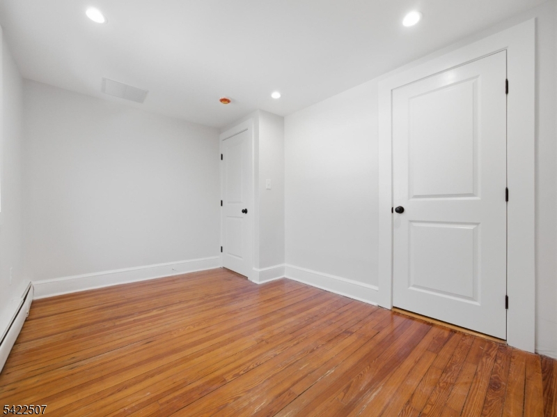 46 West End Avenue, Unit LEFT Summit, NJ 07901 - Photo 14 of 19 a view of an empty room with wooden floor