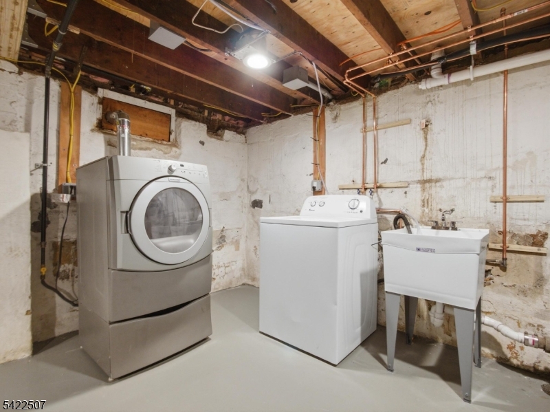 46 West End Avenue, Unit LEFT Summit, NJ 07901 - Photo 17 of 19 a utility room with dryer and washer