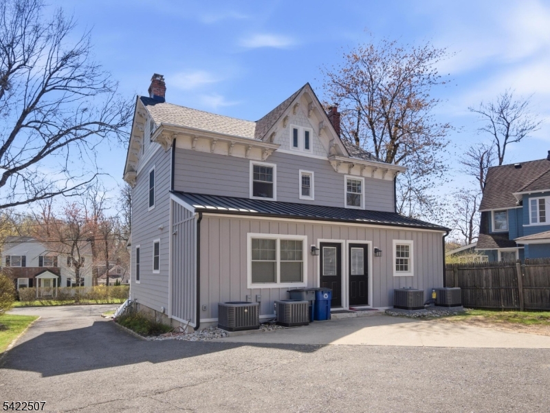 46 West End Avenue, Unit LEFT Summit, NJ 07901 - Photo 18 of 19 a front view of a house with a yard