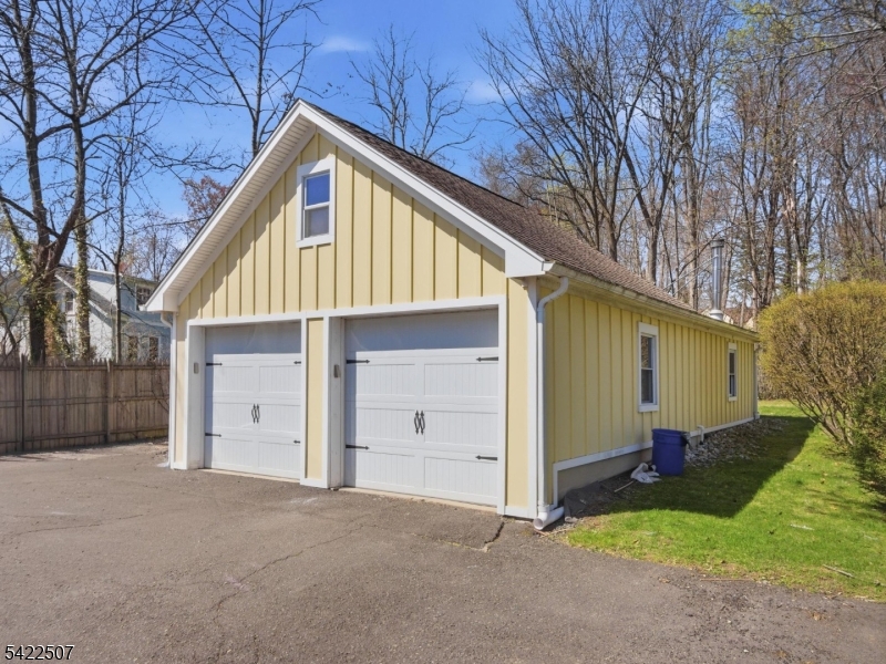 46 West End Avenue, Unit LEFT Summit, NJ 07901 - Photo 19 of 19 a view of a house with a yard and garage