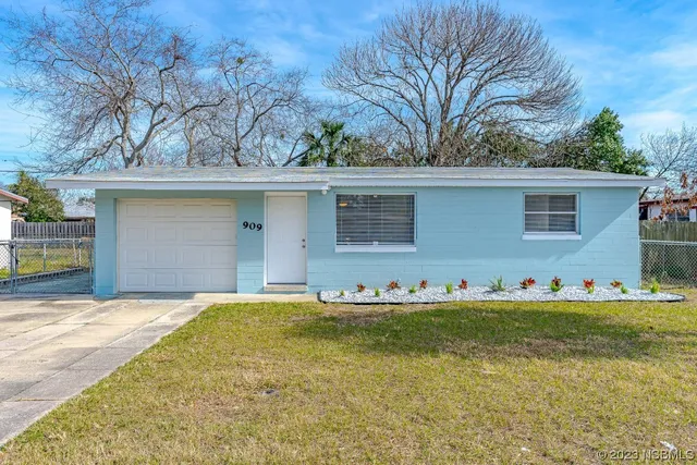 an aerial view of a backyard with chairs