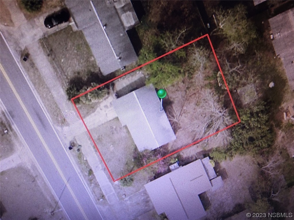 909 Derbyshire Road Daytona Beach, FL 32117 - Photo 18 of 18 an aerial view of a backyard with chairs