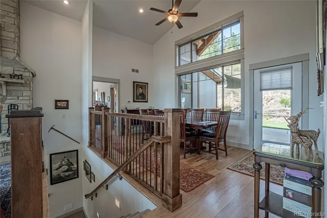 a living room with furniture a fireplace a flat screen tv and a large window