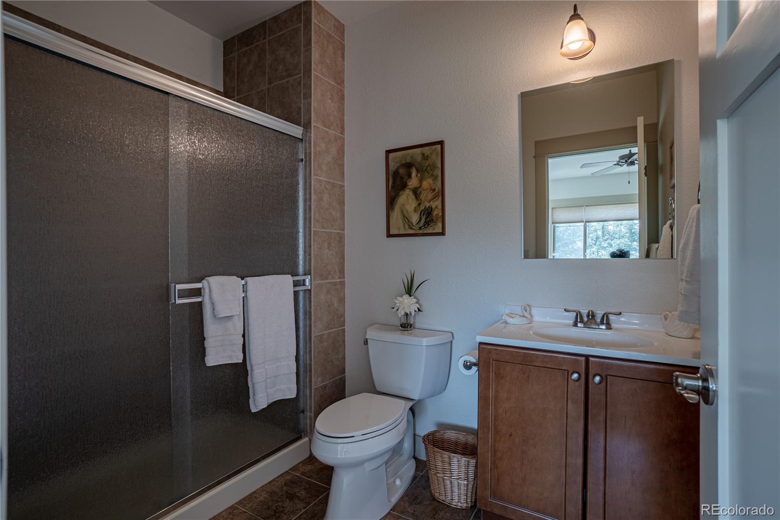 1388 Mt Moriah Road Livermore, CO 80536 - Photo 22 of 40 a bathroom with a sink toilet and mirror