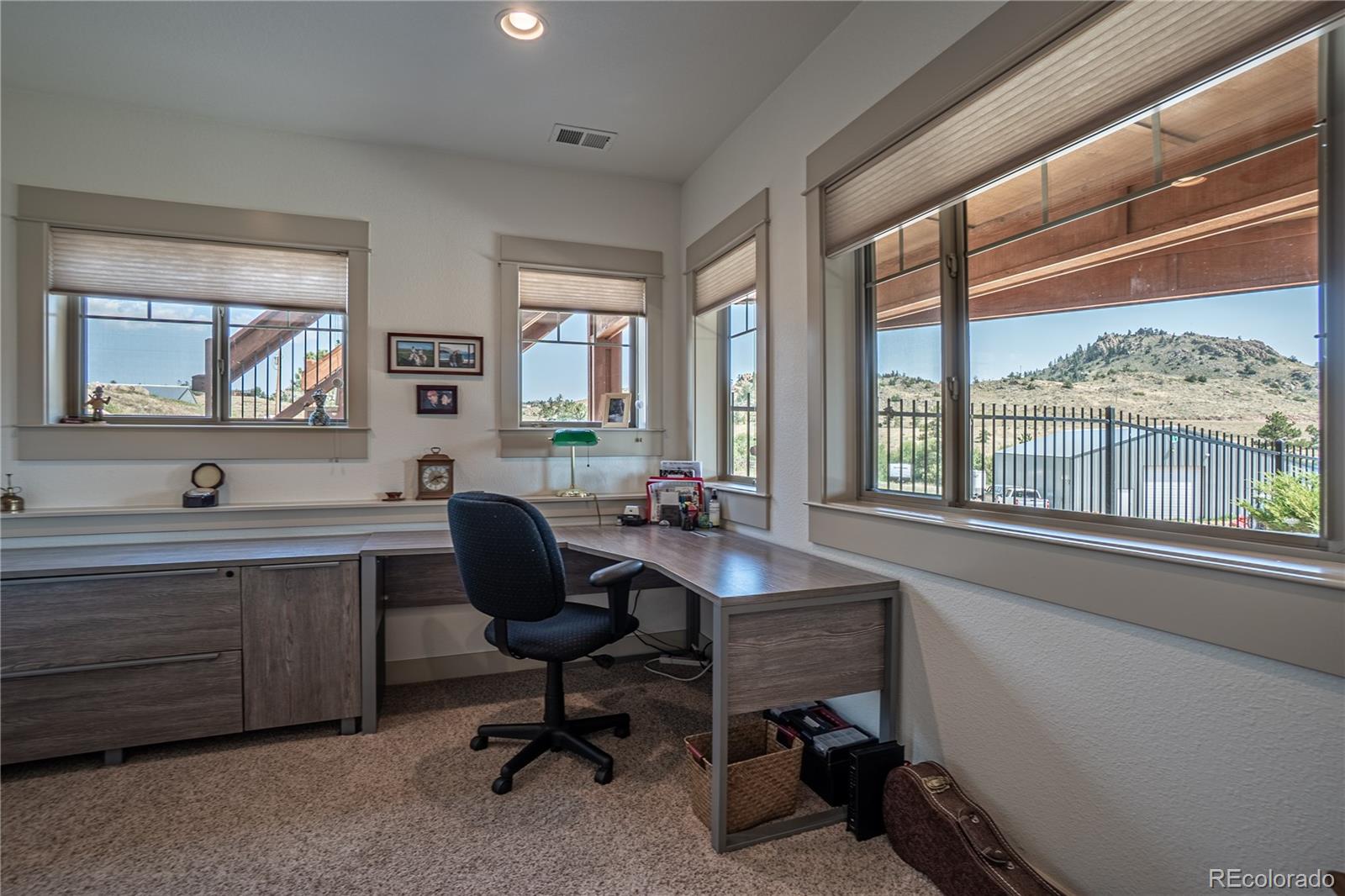 1388 Mt Moriah Road Livermore, CO 80536 - Photo 23 of 40 a view of a workspace with furniture and a window
