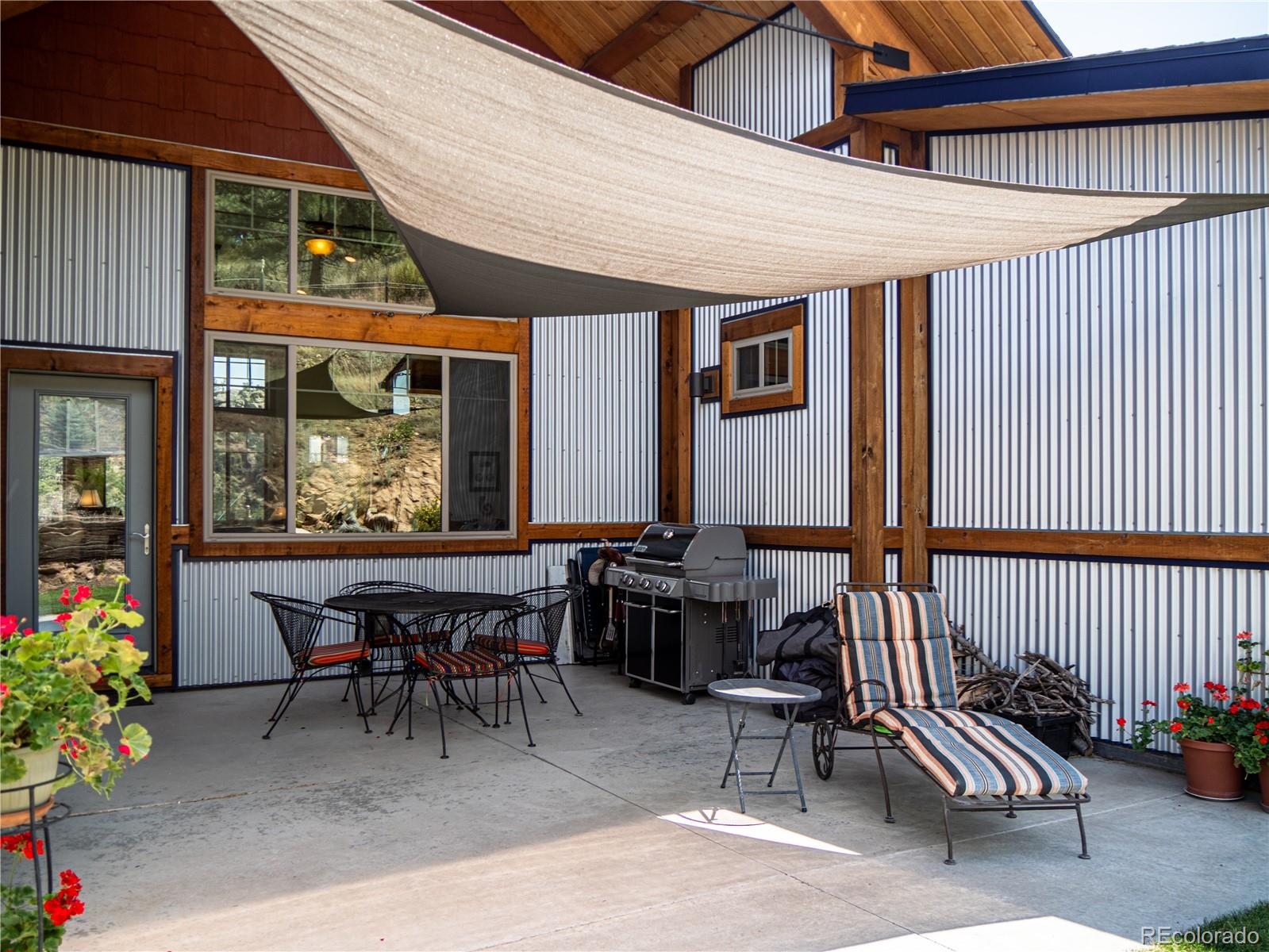 1388 Mt Moriah Road Livermore, CO 80536 - Photo 28 of 40 a view of a patio with a dining table and chairs