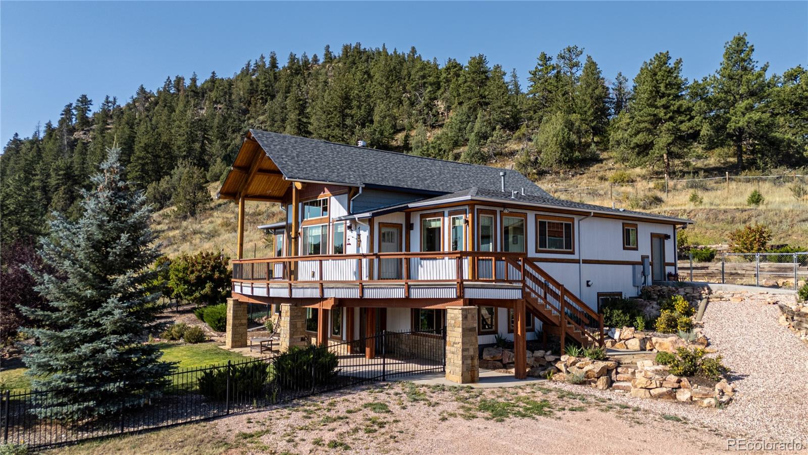 1388 Mt Moriah Road Livermore, CO 80536 - Photo 8 of 40 a front view of a house with a tree
