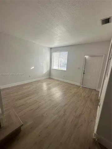 an aerial view of ocean with residential house and outdoor space