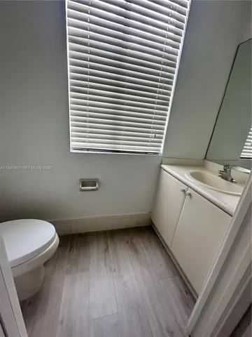 a bathroom with a toilet and a window