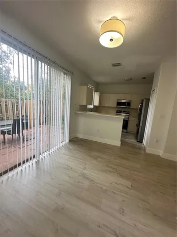 a kitchen with a refrigerator and a sink