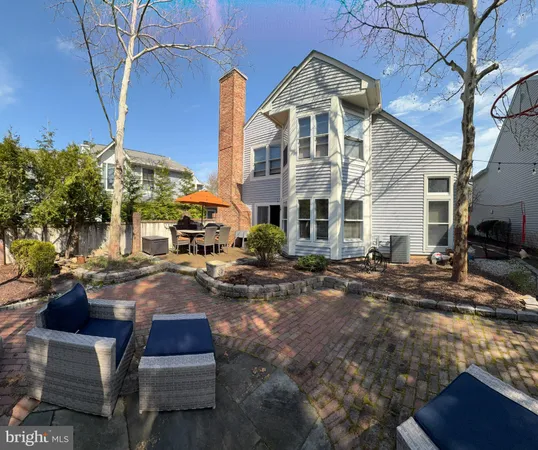 a front view of a house with yard and sitting area