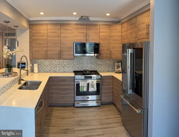 a kitchen with stainless steel appliances granite countertop a sink and a stove