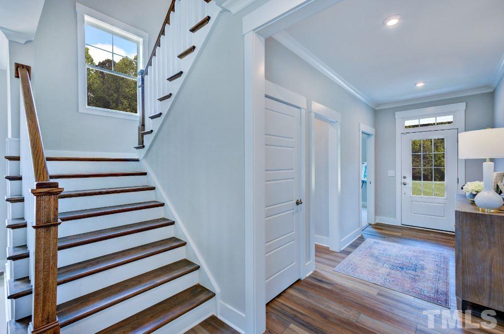 192 DUNLOE Loop Raleigh, NC 27603 - Photo 13 of 19 a view of entryway with wooden floor and stairs