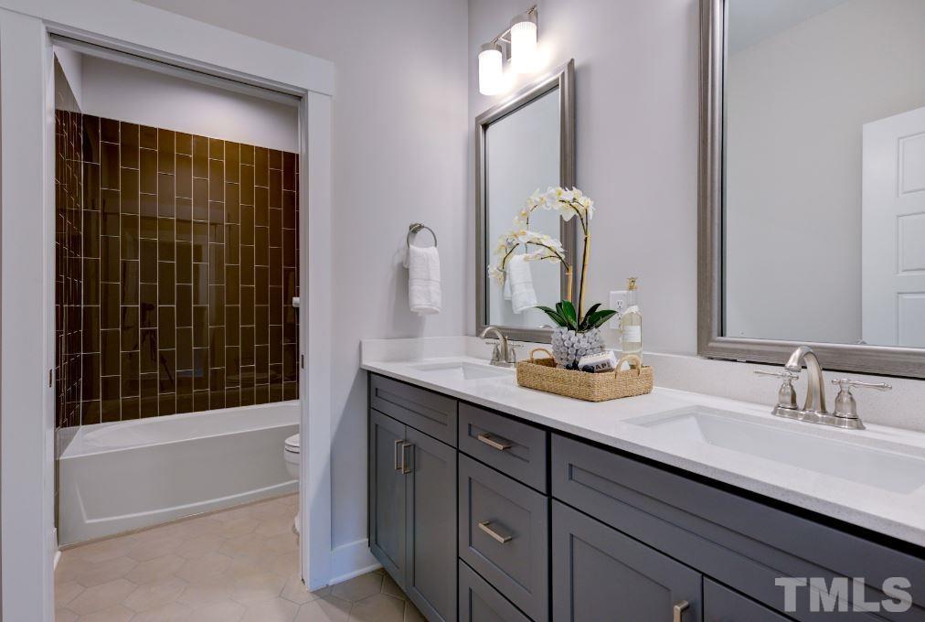 192 DUNLOE Loop Raleigh, NC 27603 - Photo 8 of 19 a bathroom with a double vanity sink and a mirror