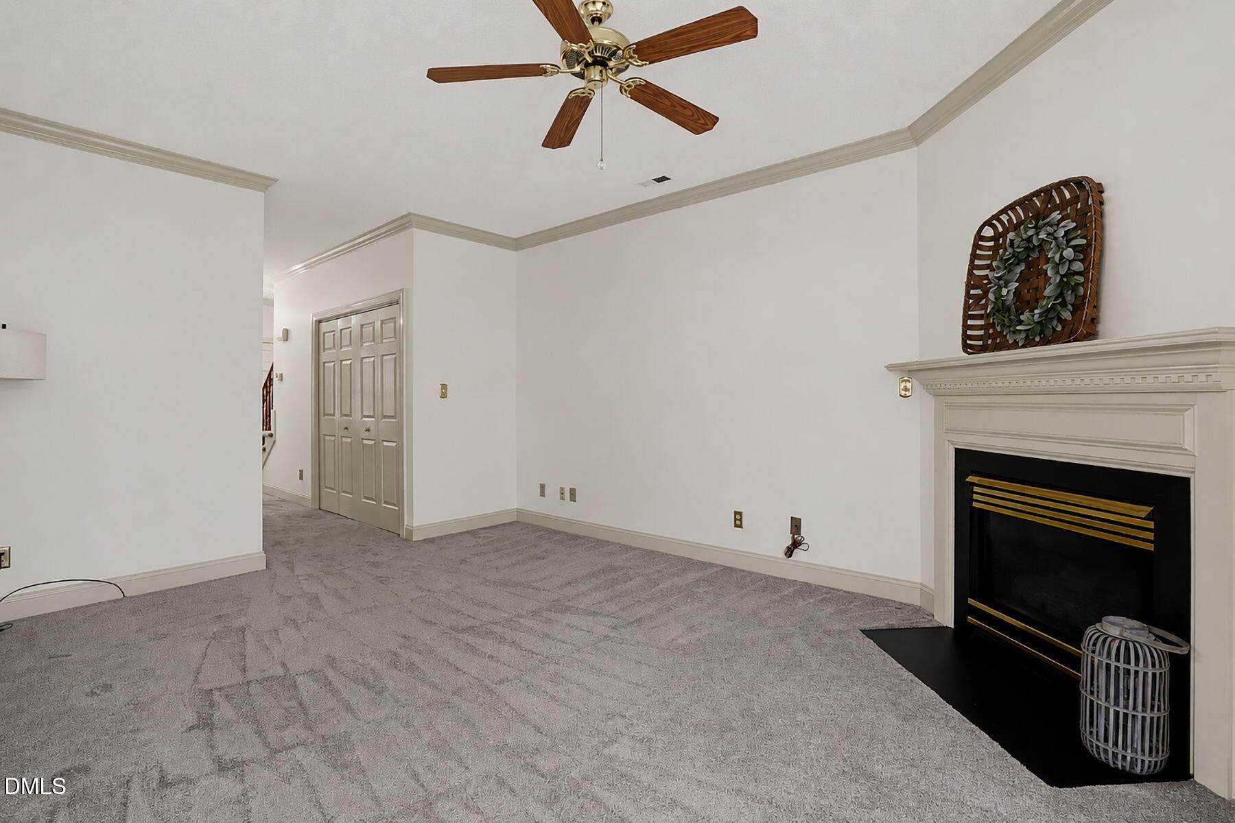 1210 Shadow Bark Court Raleigh, NC 27603 - Photo 12 of 29 a view of an empty room with a fireplace and a ceiling fan