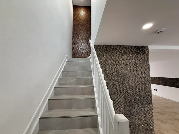 a view of staircase with white walls