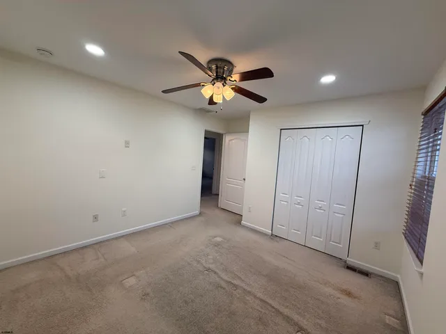 a view of room with a ceiling fan and window