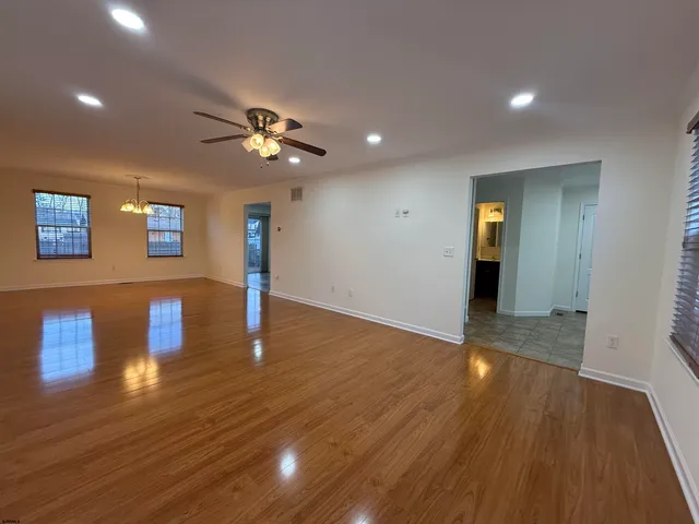 a view of an empty room and wooden floor