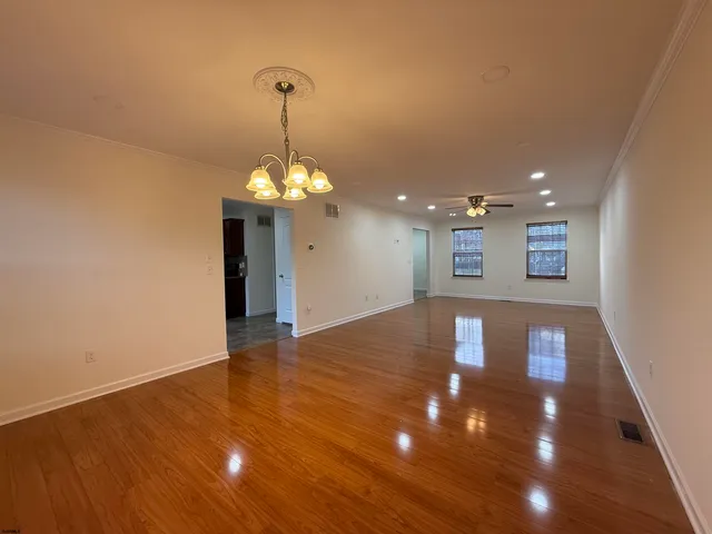 a view of a room with wooden floor