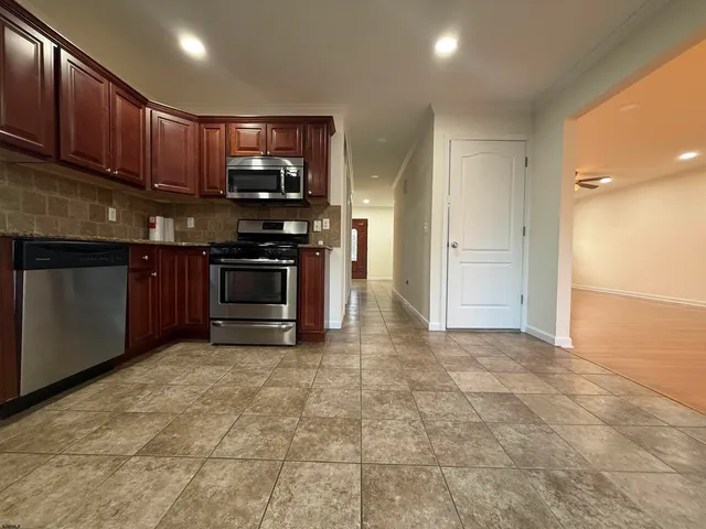 a kitchen with stainless steel appliances granite countertop a stove cabinets and a sink