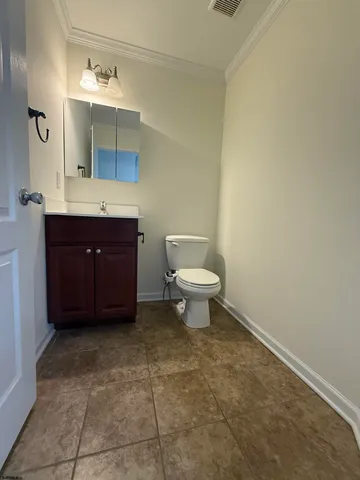 a bathroom with a sink vanity and a toilet