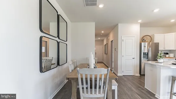 a view of hallway with chandelier and a window
