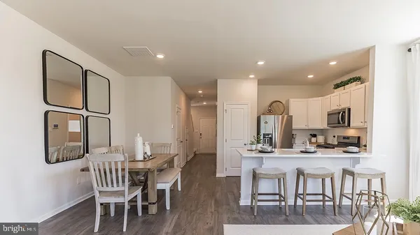 a large kitchen with a table and chairs