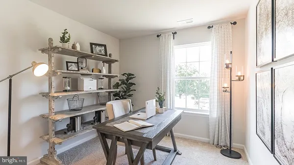 a workspace with furniture and a book shelf