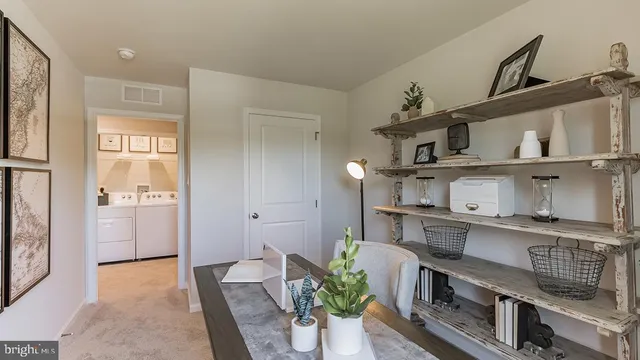 a living room with furniture and a book shelf