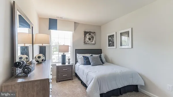 a bedroom with a bed and glass window