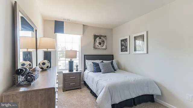 a bedroom with a bed and glass window