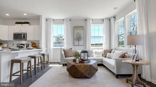 a living room with furniture flat screen and a window