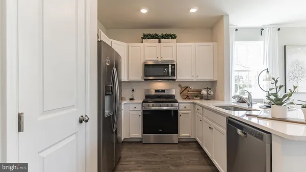a kitchen with stainless steel appliances granite countertop a sink and a stove