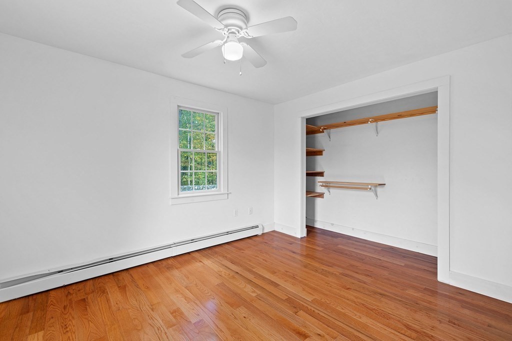 756 Bemis Road Warren, MA 01585 - Photo 19 of 41 a view of empty room with wooden floor and fan