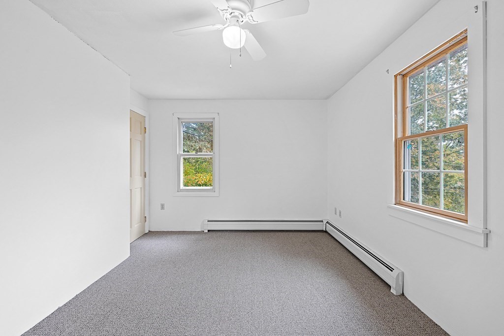 756 Bemis Road Warren, MA 01585 - Photo 21 of 41 an empty room with windows and fan