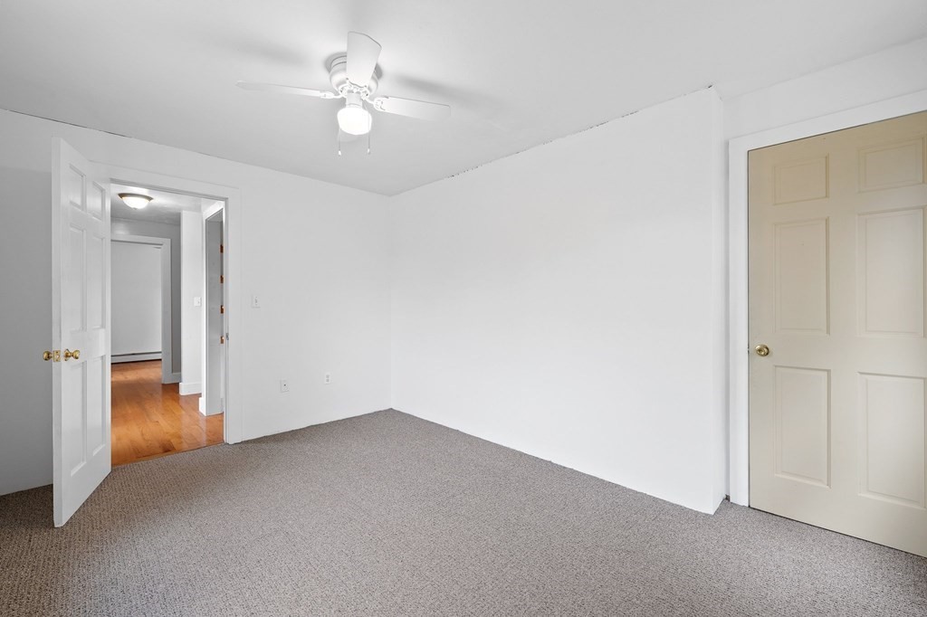 756 Bemis Road Warren, MA 01585 - Photo 22 of 41 an empty room with a ceiling fan and a bathroom