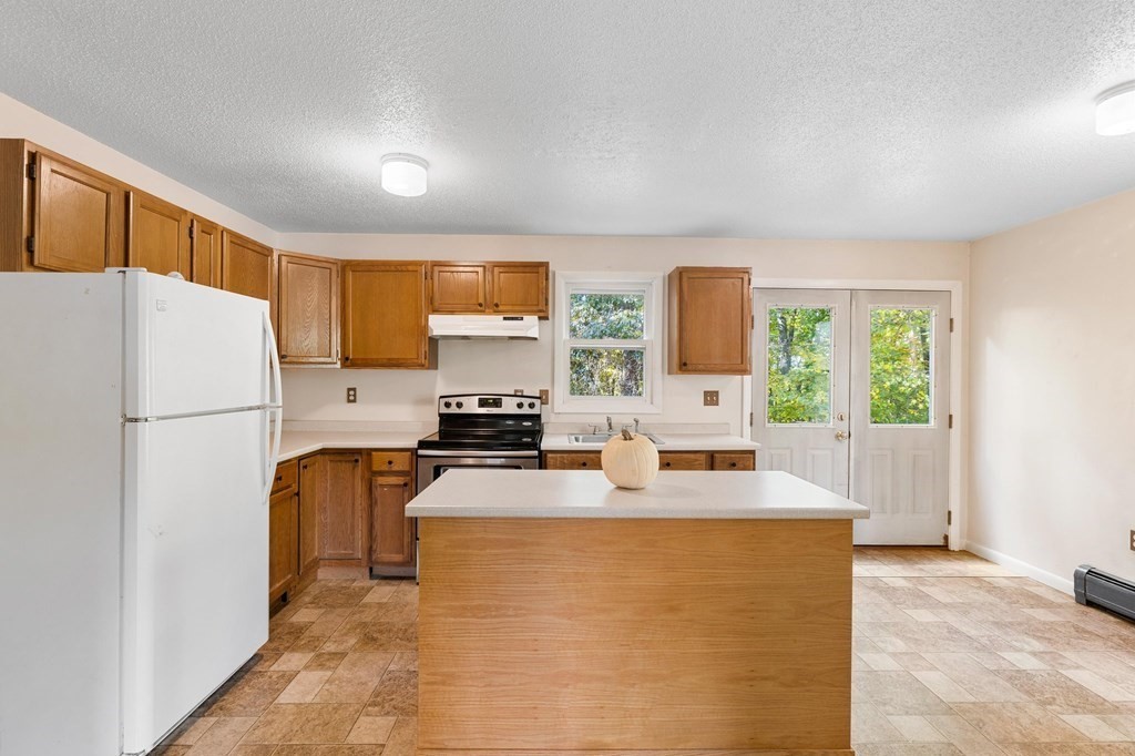 756 Bemis Road Warren, MA 01585 - Photo 27 of 41 a kitchen with stainless steel appliances a refrigerator stove microwave and sink