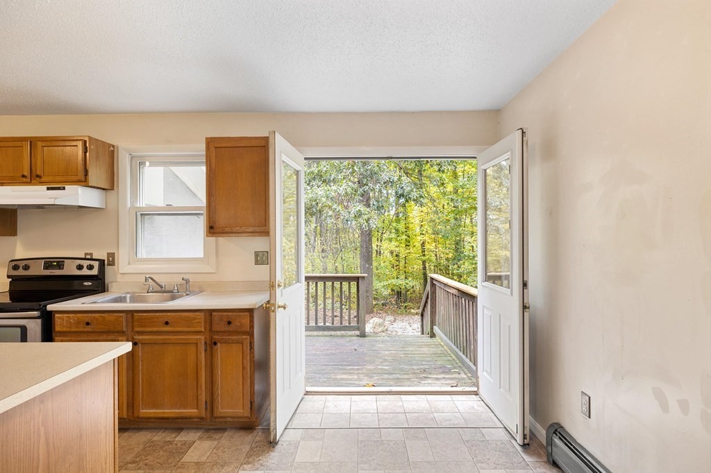 756 Bemis Road Warren, MA 01585 - Photo 29 of 41 a kitchen with a stove a sink and a refrigerator