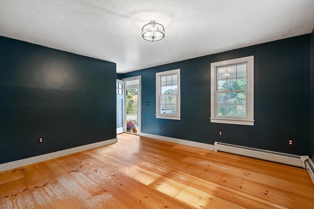 756 Bemis Road Warren, MA 01585 - Photo 4 of 41 a view of an empty room with window and wooden floor