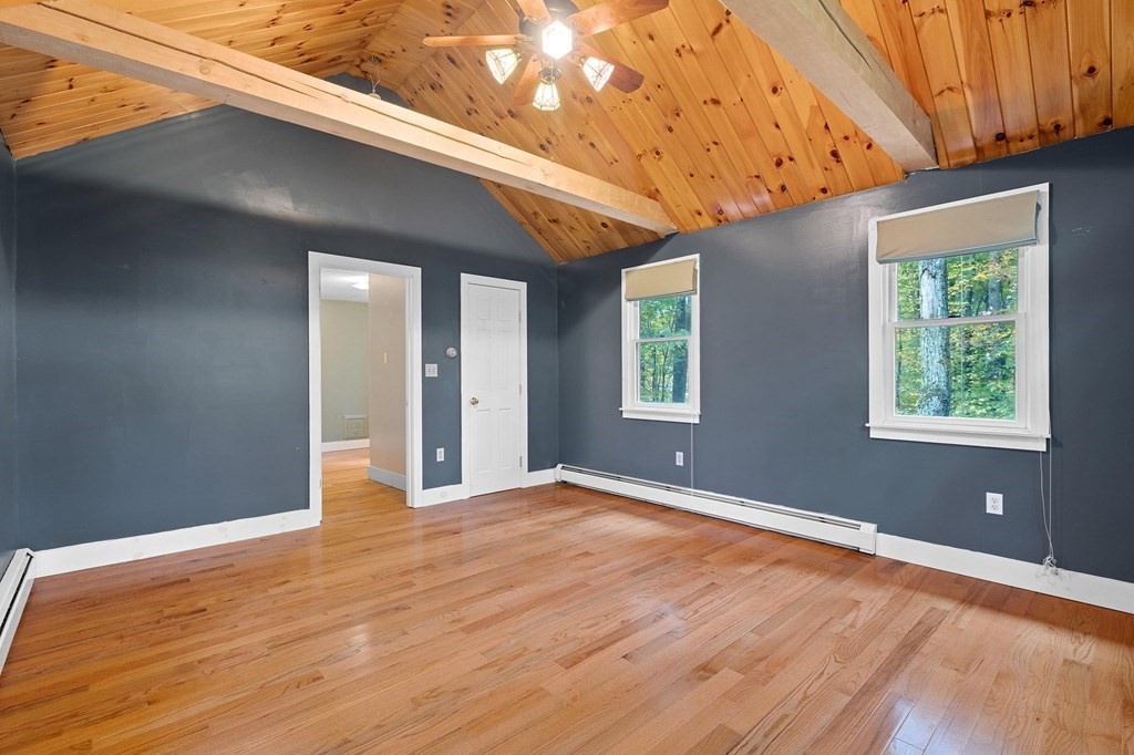 756 Bemis Road Warren, MA 01585 - Photo 9 of 41 a view of an empty room with wooden floor and a window